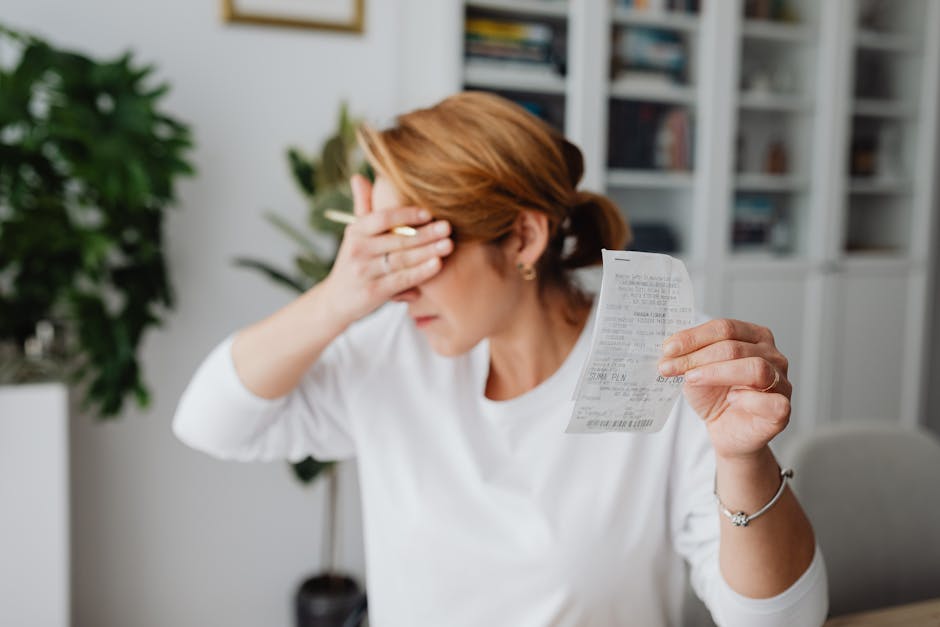 Receipts, smartphone, and laptop on a small business desk