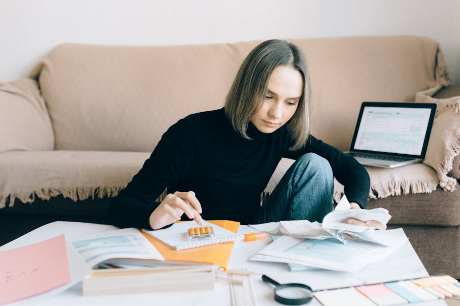 Accountant reviewing receipts on dual monitors
