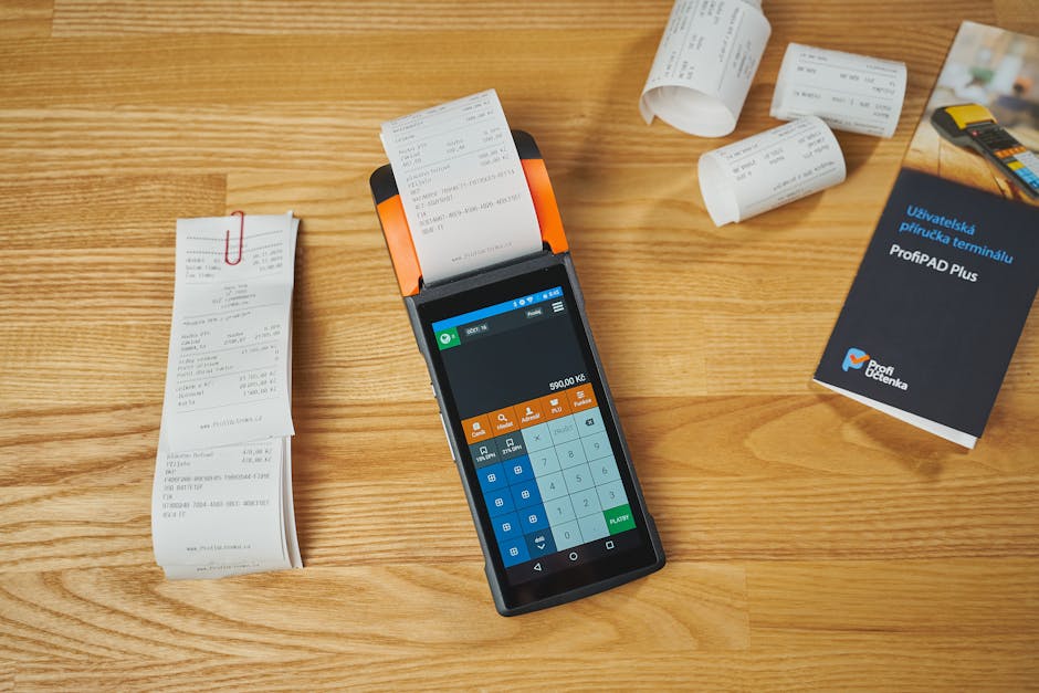 Receipts, smartphone, and laptop on a small business desk